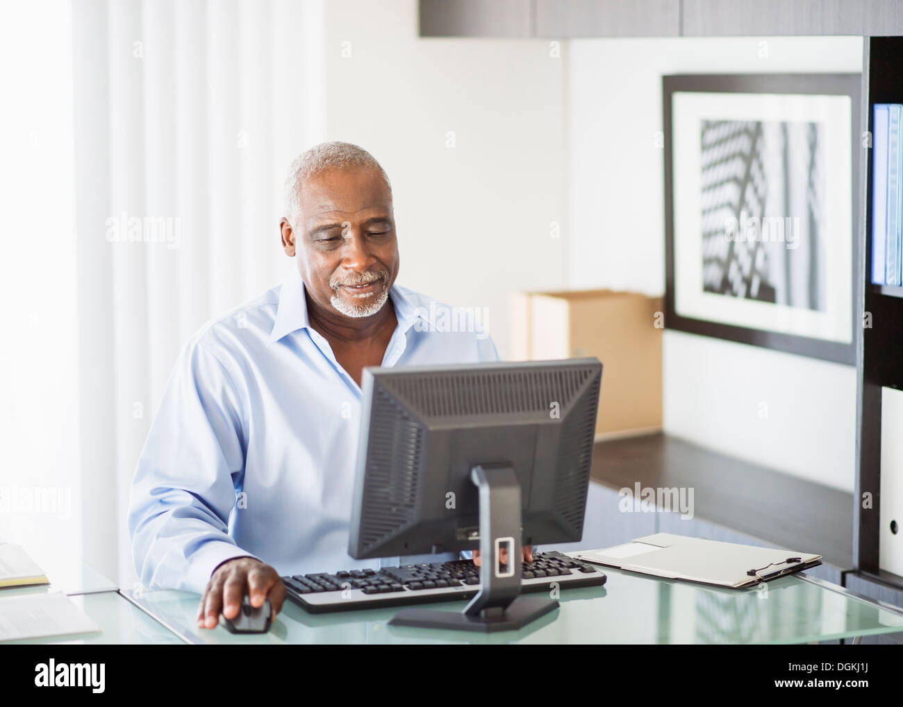 Portrait of senior man working on computer in office Stock Photo