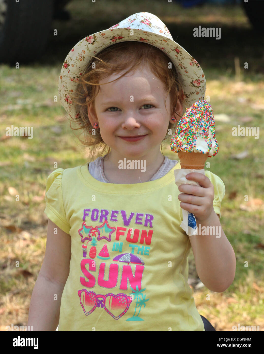 a red headed girl holding an icecream Stock Photo