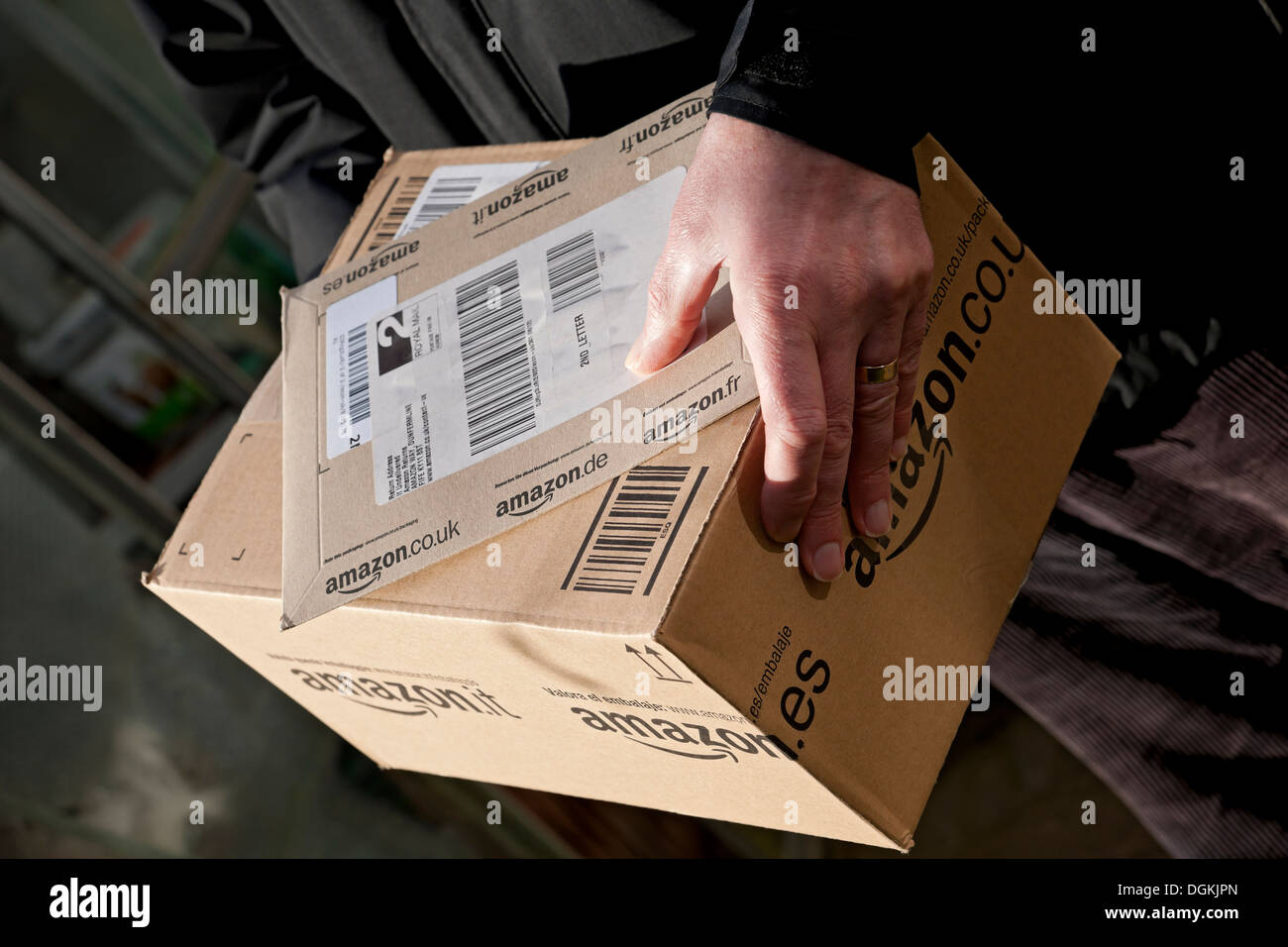 A man holding an Amazon delivery Stock Photo Alamy