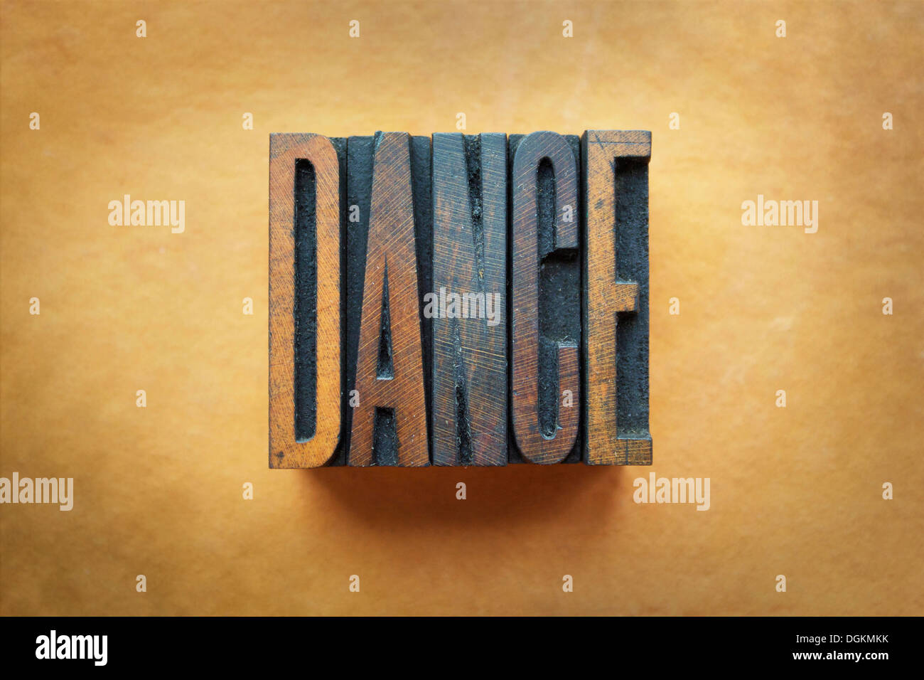 The word DANCE written in vintage letterpress type. Stock Photo