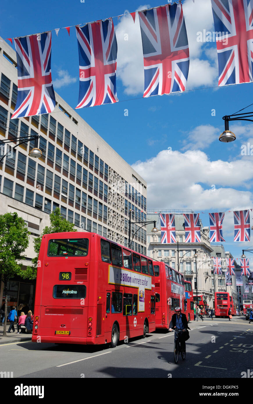 Union Jack flags and red buses in Oxford Street. Stock Photo