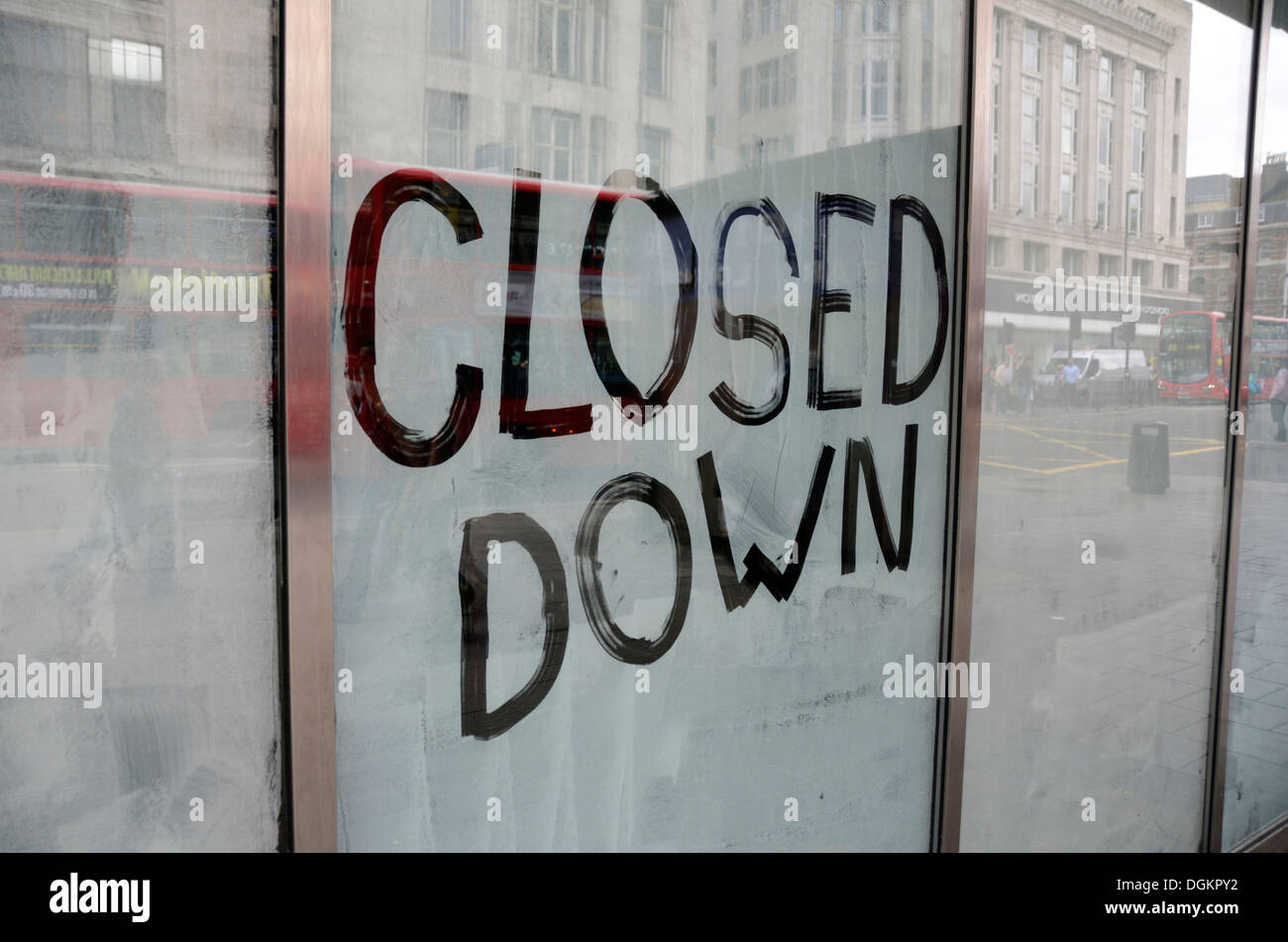 Closed Down written on a shop window. Stock Photo