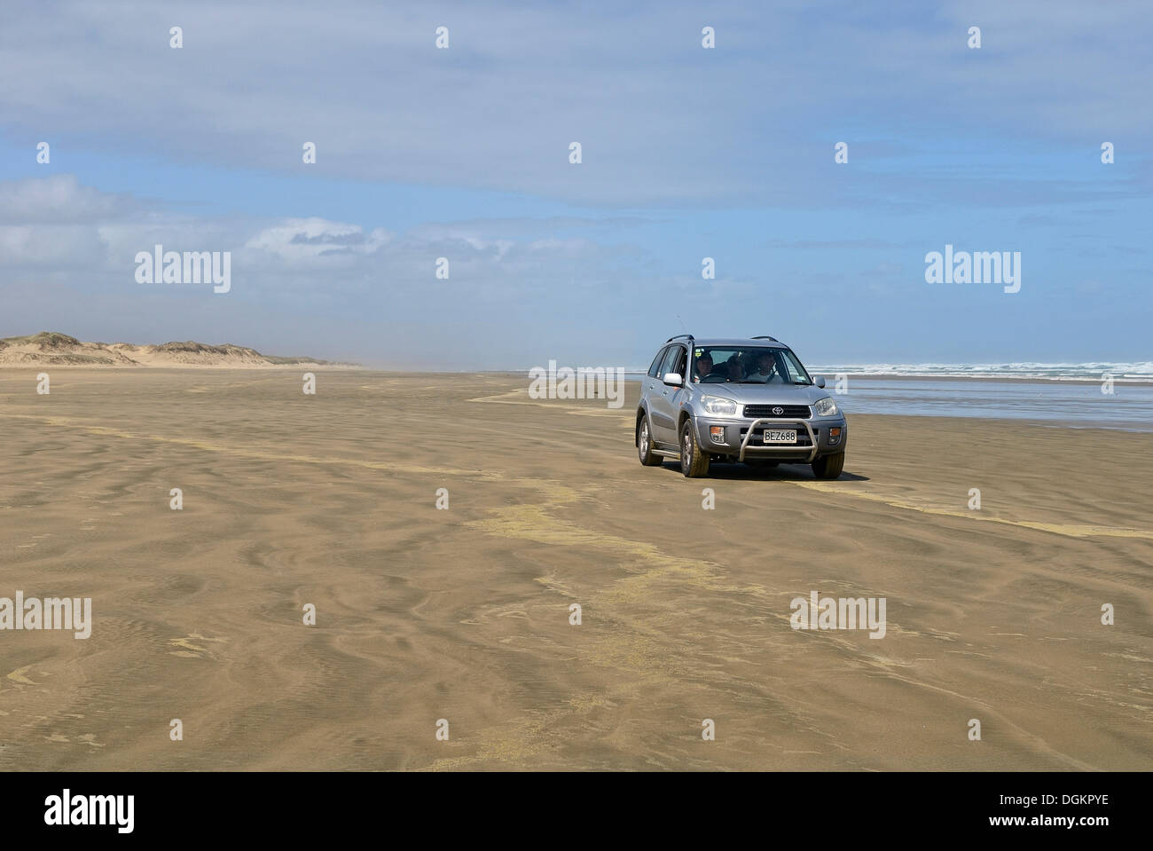 Car driving at low tide on Ninety Mile Beach, Hukatere, North Island, New Zealand Stock Photo