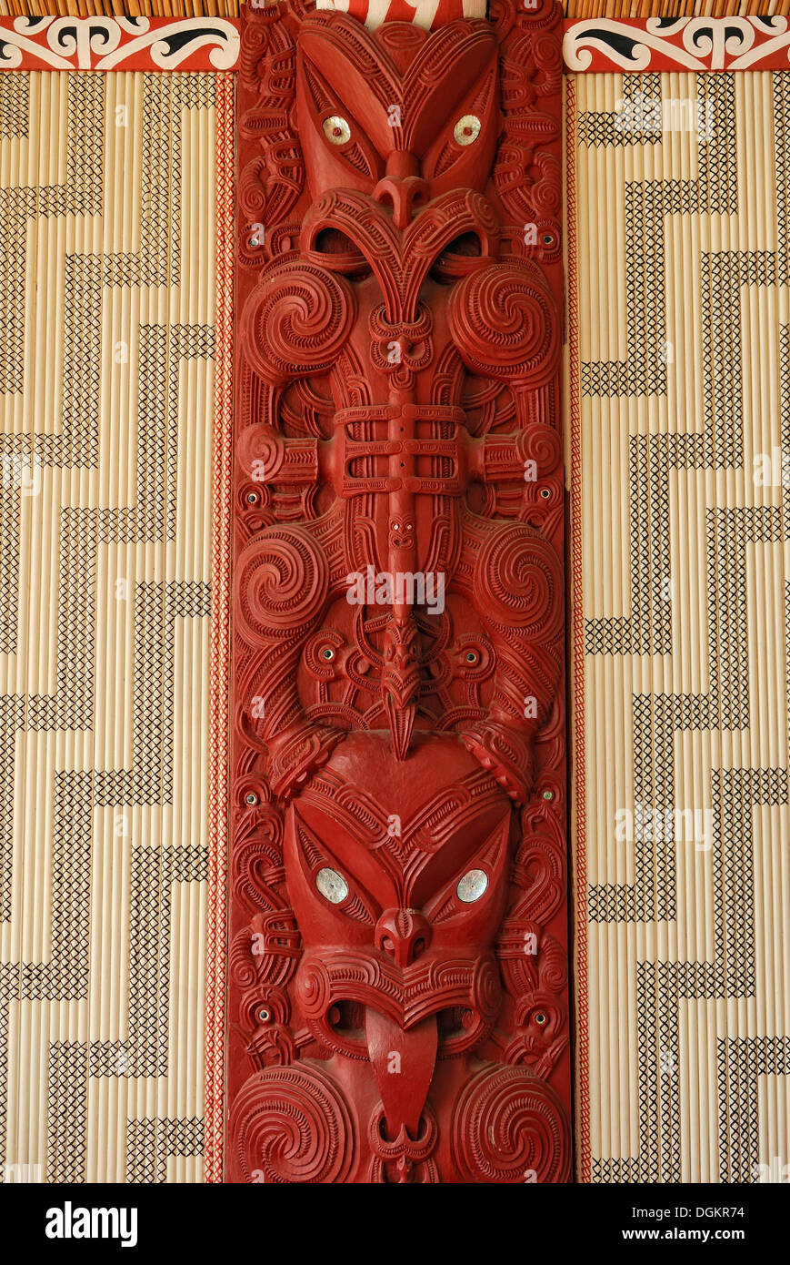 Maori carving, wooden relief with mother of pearl inlays, figural representation and ornaments, Maori Meeting House Stock Photo