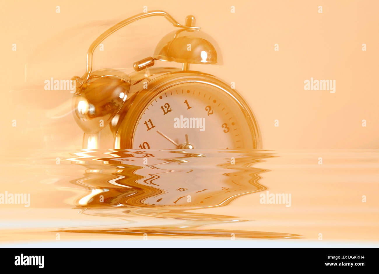 Sinking larm clock, symbolic image for the end of time Stock Photo - Alamy
