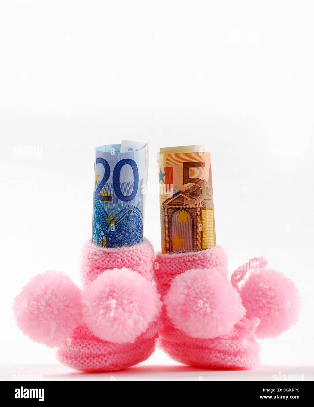 Baby shoes with euro notes, symbolic image for child allowance Stock Photo