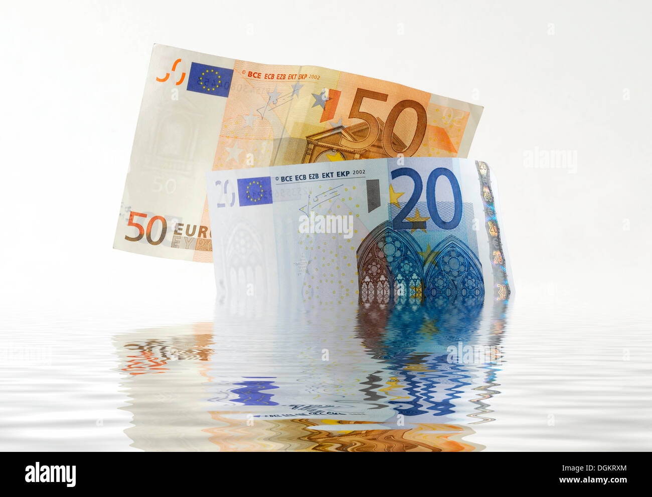 Euro notes sinking in water Stock Photo