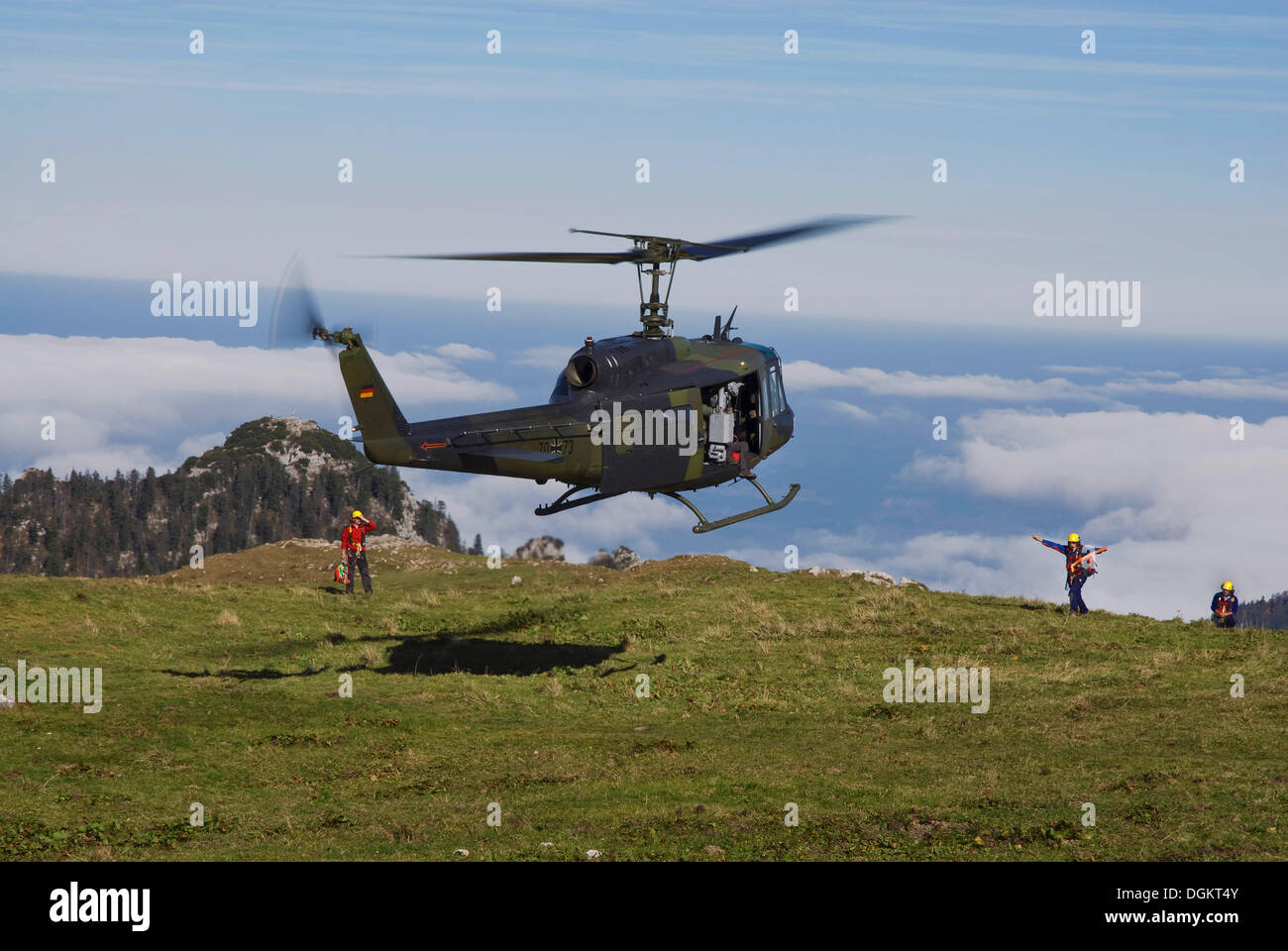 Landing Bundeswehr military helicopter marshalled by rescue personnel, Bavarian Alps, Upper Bavaria, Bavaria Stock Photo