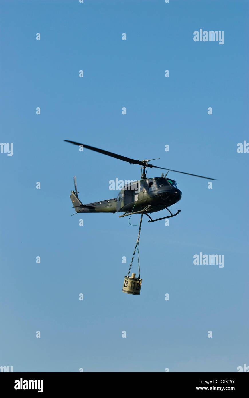 Bundeswehr, federal army, helicopter Bell UH-1D HUEY with water tank in fire-fighting operation, in flight, PublicGround Stock Photo