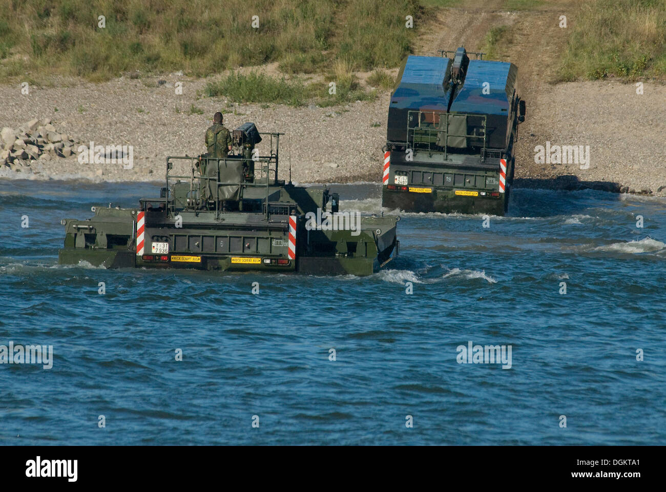Two M3 amphibious vehicles of the Bundeswehr, federal army, emerging from the Rhine, one with folded wings Stock Photo