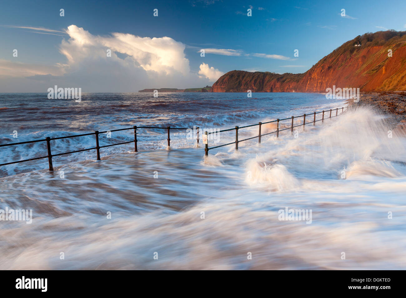 Waves crashing over the walkway in Sidmouth. Stock Photo