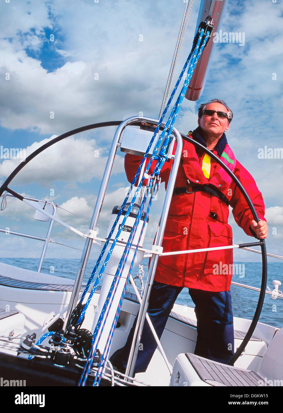 Skipper at the helm of his sailboat Stock Photo Alamy
