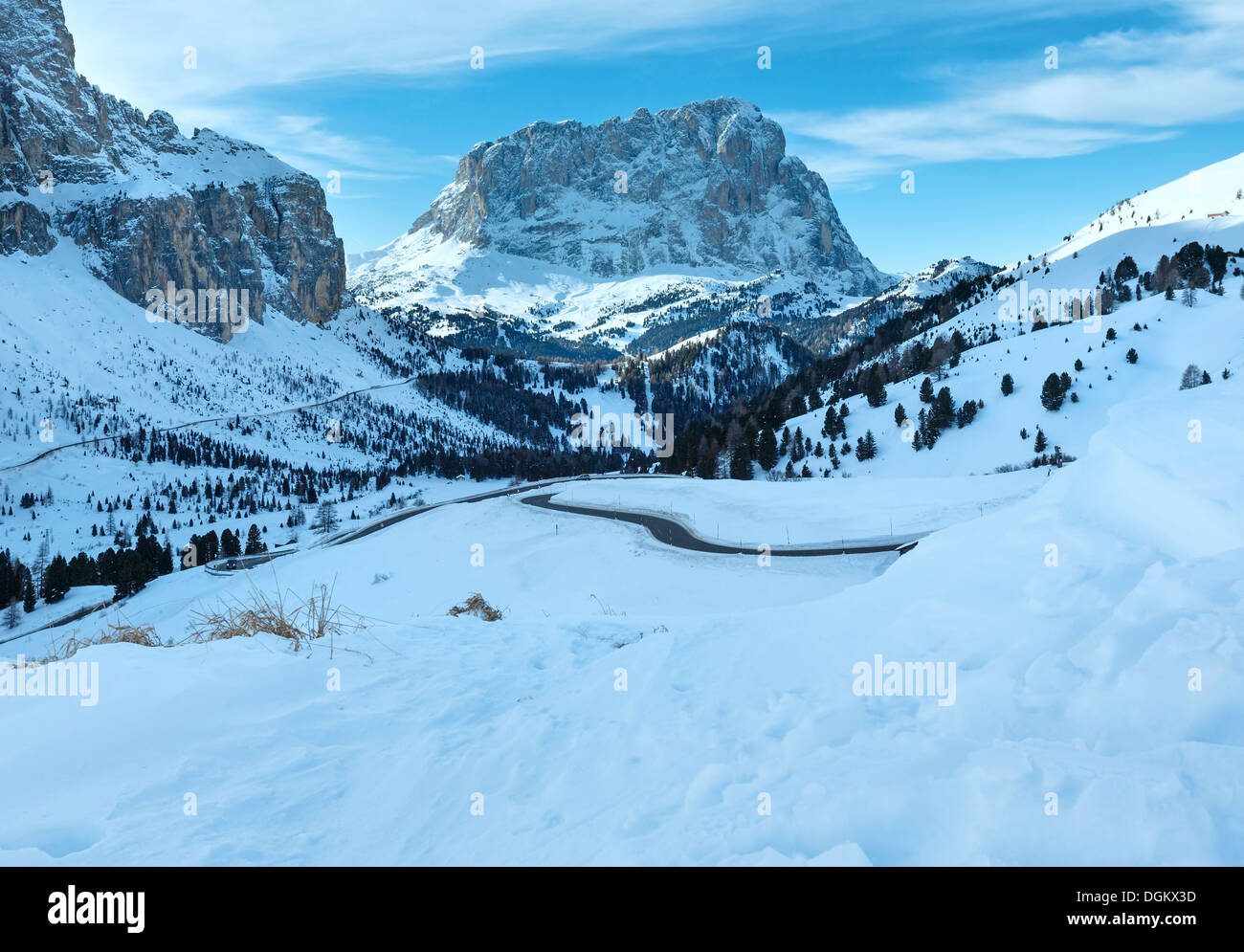 Morning winter rocky mountain landscape with serpentine road . Gardena Pass in Dolomites of South Tyrol in northeast Italy. Stock Photo