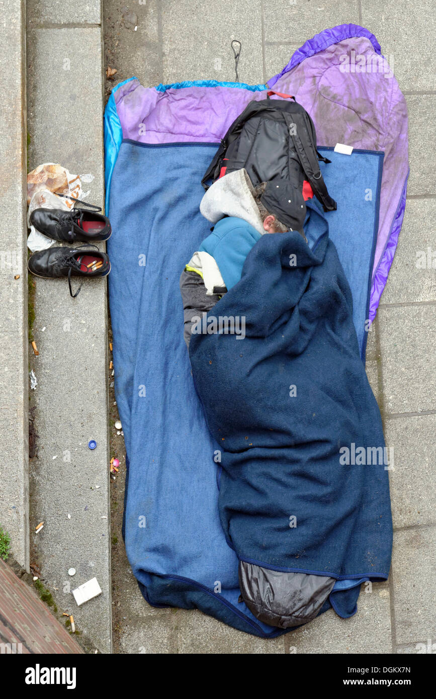 Homeless man sleeping on the ground, Hamburg, Hamburg, Germany Stock Photo