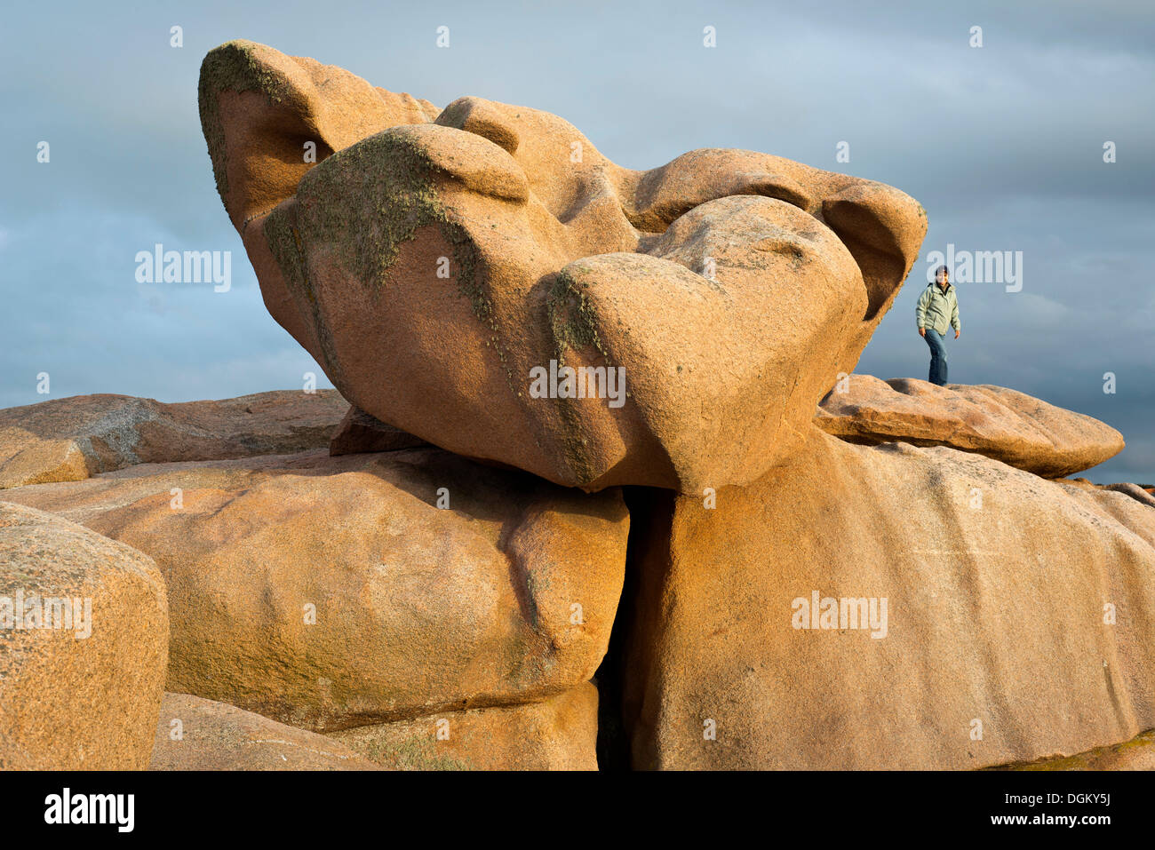 https://c8.alamy.com/comp/DGKY5J/woman-standing-next-to-a-very-large-boulder-evening-light-cte-de-granit-DGKY5J.jpg