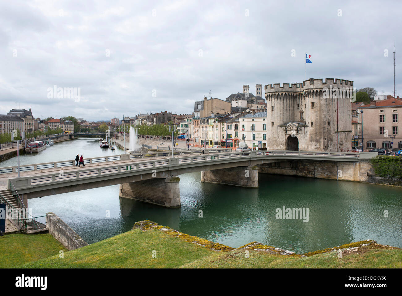 The Maas river with a road bridge, historical town gate and houses on the waterfront, Verdun, Lorraine, France, Europe Stock Photo
