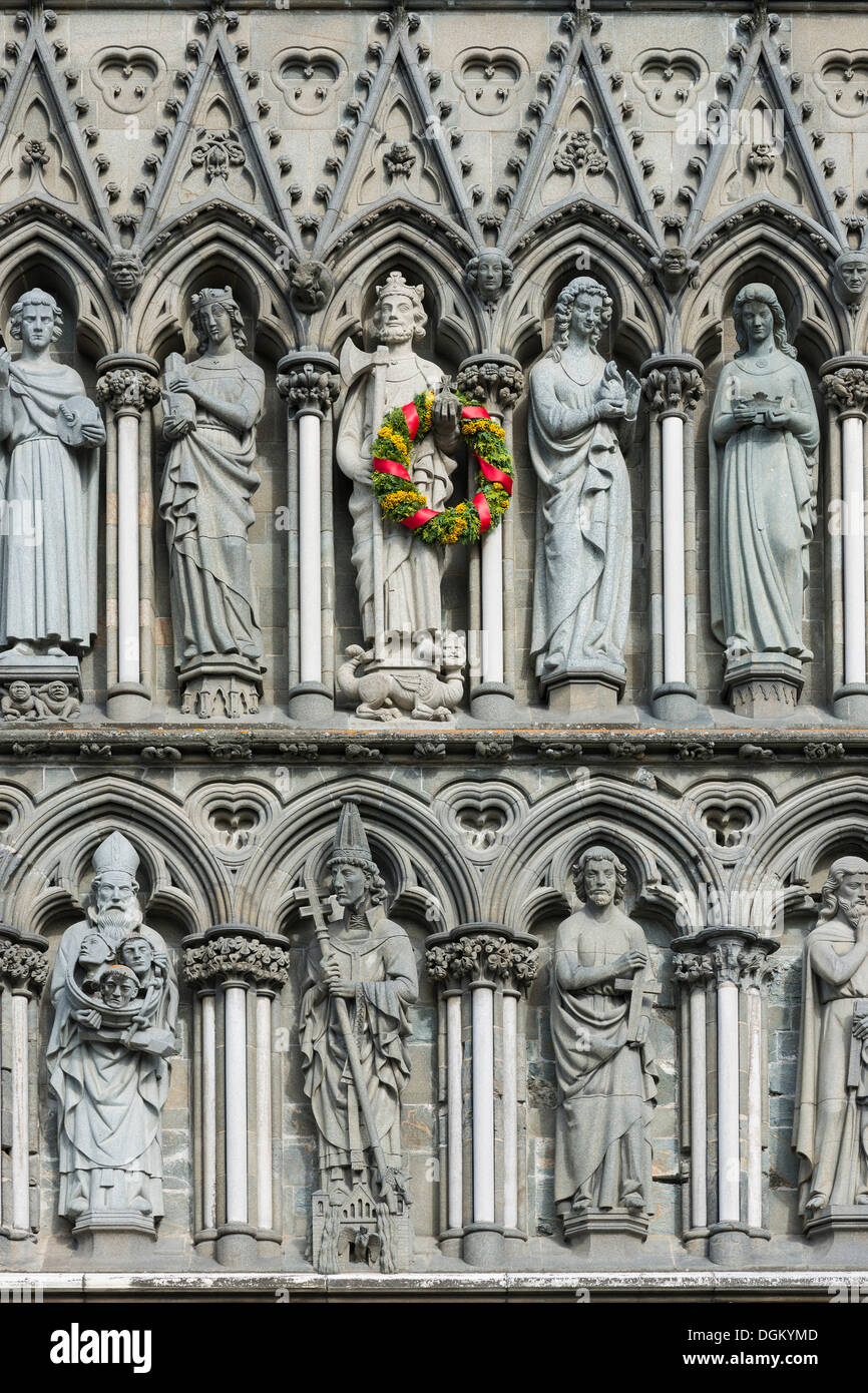 West facade on Nidaros Cathedral in Trondheim, detail with statues of saints, King Olaf II Haraldsson is decorated with a wreath Stock Photo