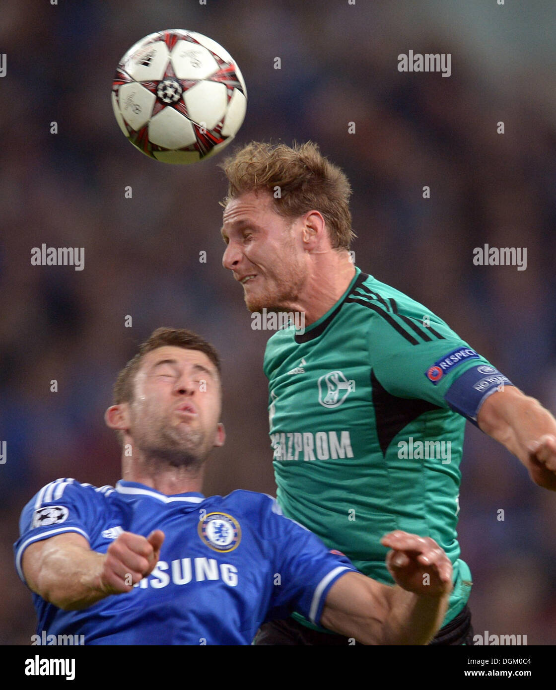 Gelsenkirchen, Germany. 22nd Oct, 2013. Schalke's Benedikt Hoewedes (R) vies for the ball with Chelsea's Gary Cahill during the Champions League group E soccer match betwen FC Schalke 04 and FC Chelsea at the Gelsenkirchen stadium in Gelsenkirchen, Germany, 22 October 2013. Photo: Federico Gambarini/dpa/Alamy Live News Stock Photo