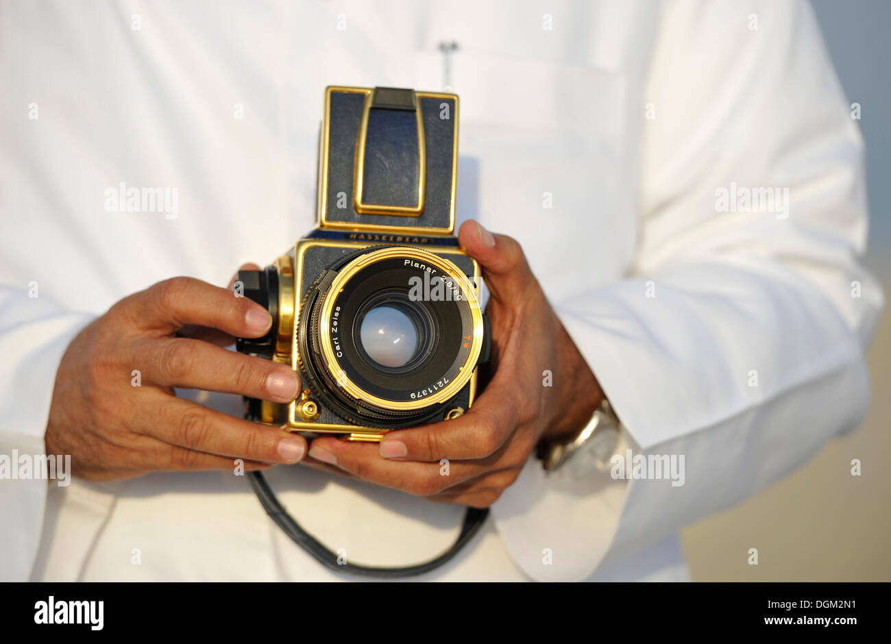 Arabians presenting his gilded Hasselblad with Carl Zeiss Planar Lens 2, 8-80mm Stock Photo
