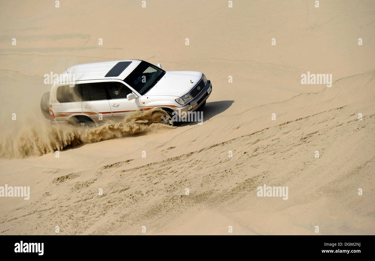 Off-roader Toyota Land Cruiser 4x4, driving in sand dunes, Emirate of Qatar, Persian Gulf, Middle East, Asia Stock Photo