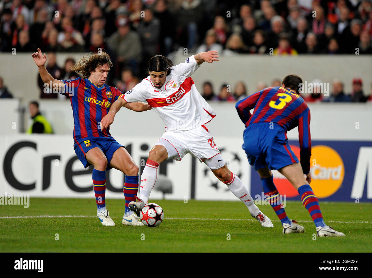 Tackling, Sami Khedira, VfB Stuttgart in the middle, vs Carles Puyol, FC Barcelona, left, and Gerard PIQUE, right Stock Photo