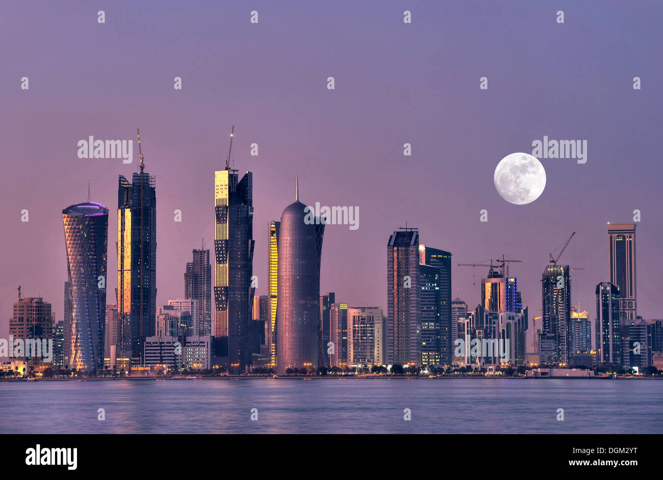 Skyline of Doha, Tornado Tower, Navigation Tower, Peace Towers, Al-Thani Tower, at dusk, Qatar, Persian Gulf, Middle East, Asia Stock Photo