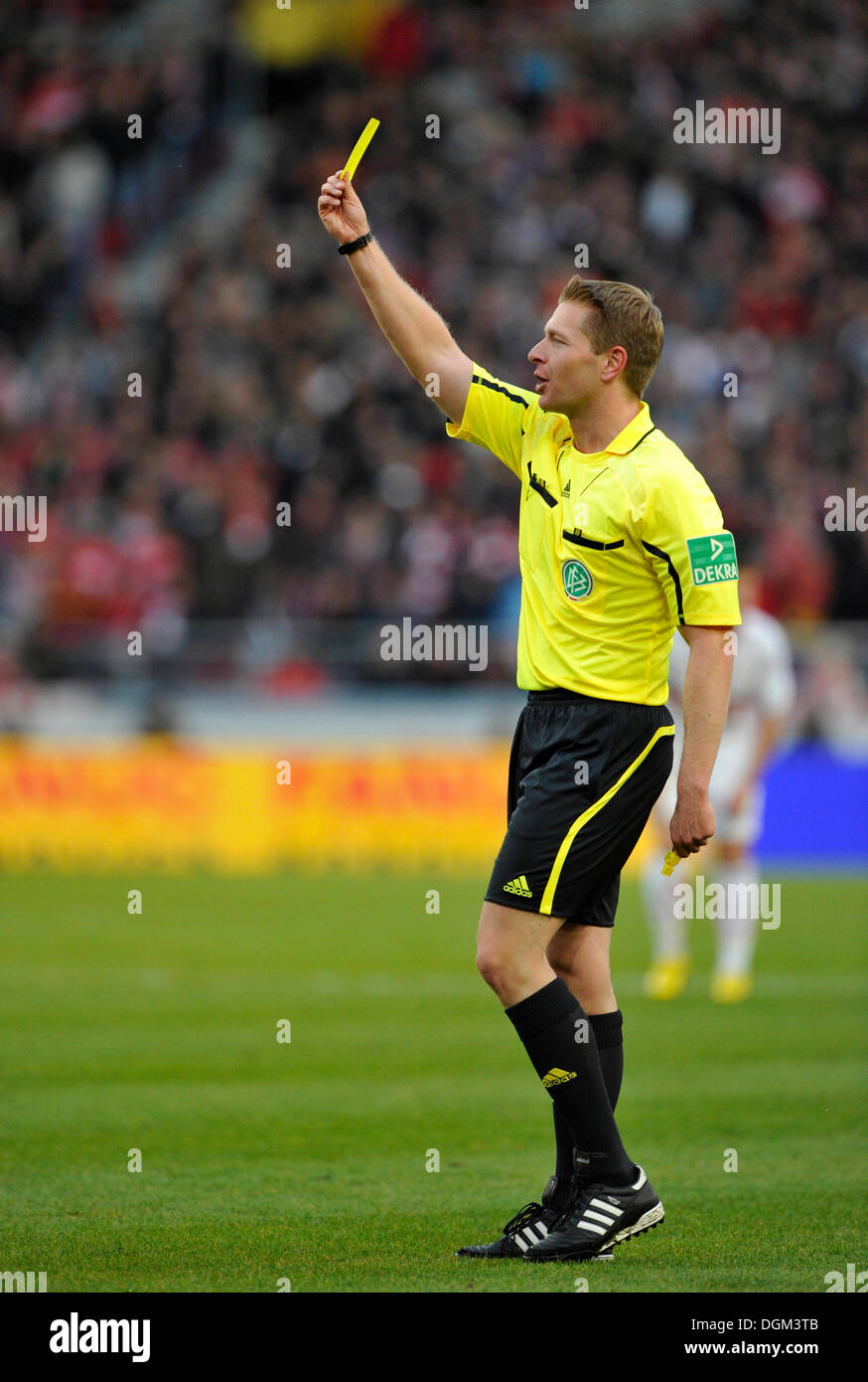 Referee Tobias WELZ giving the yellow card, warning Stock Photo