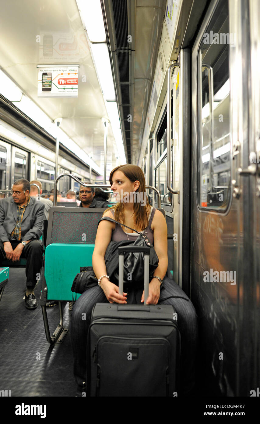 Young woman with a suitcase in the Metro, Paris, France, Europe Stock