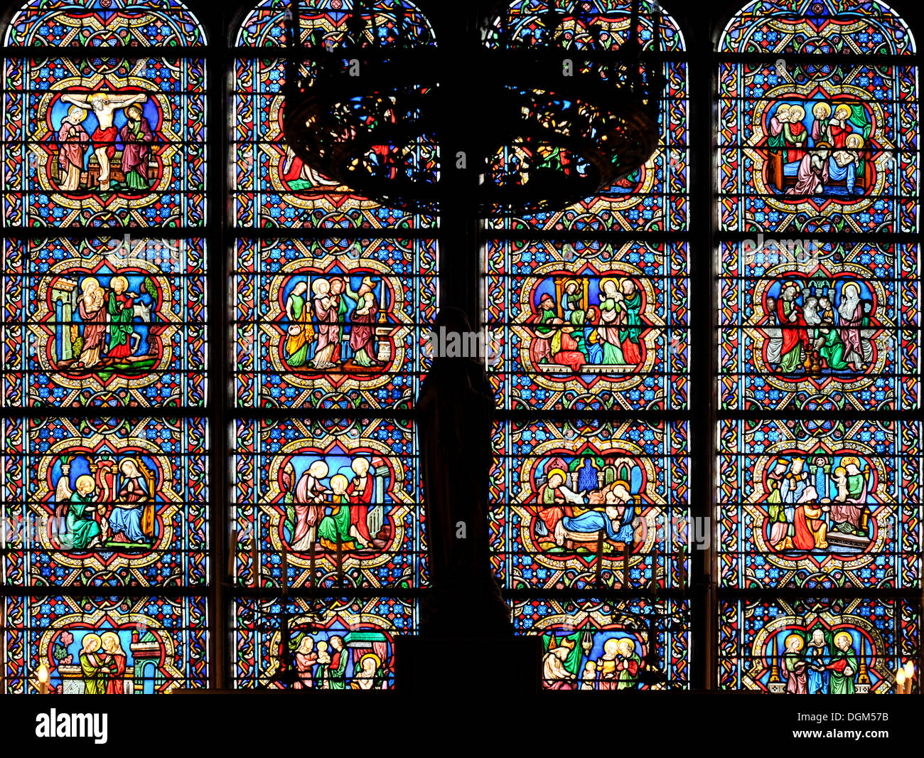 Historic stained glass window in the sanctuary, Chapelle Notre-Dame des Sept Douleurs chapel, Cathedral of Notre-Dame de Paris Stock Photo
