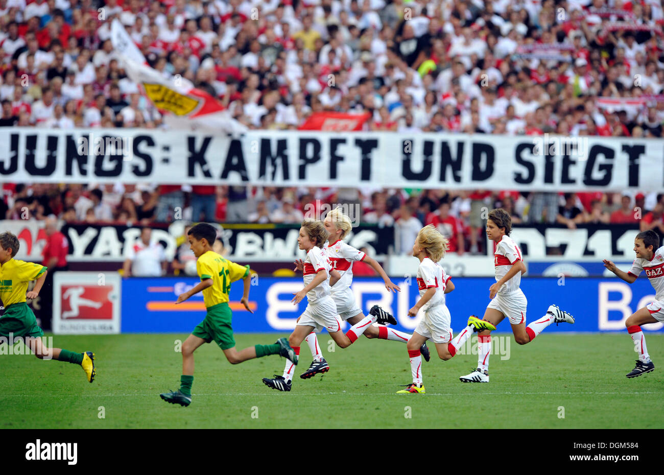 Incoming children in front of a banner, 'Jungs: Kaempft und siegt', German for 'Boys: Fight and win', Mercedes-Benz Arena Stock Photo