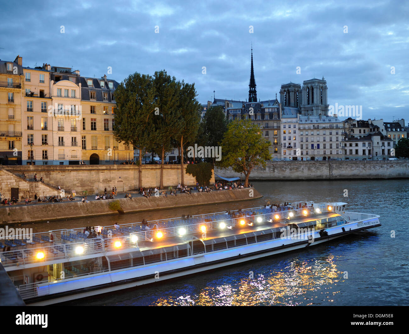 Bateaux Mouches on the Seine, excursion boat with spotlights, Notre Dame de Paris or Notre Dame Cathedral at back Stock Photo