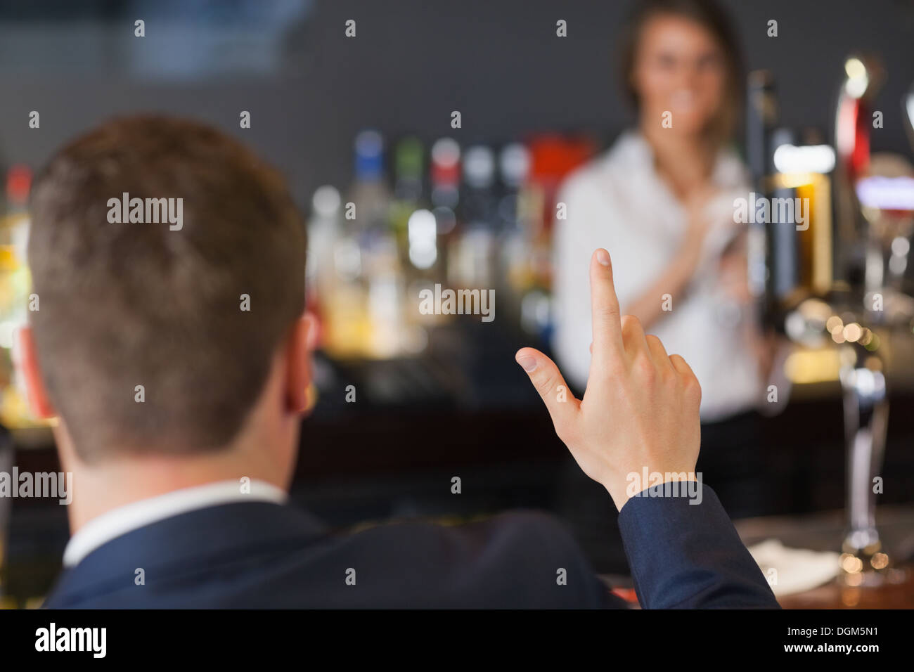 Handsome man ordering a drink from pretty waitress Stock Photo