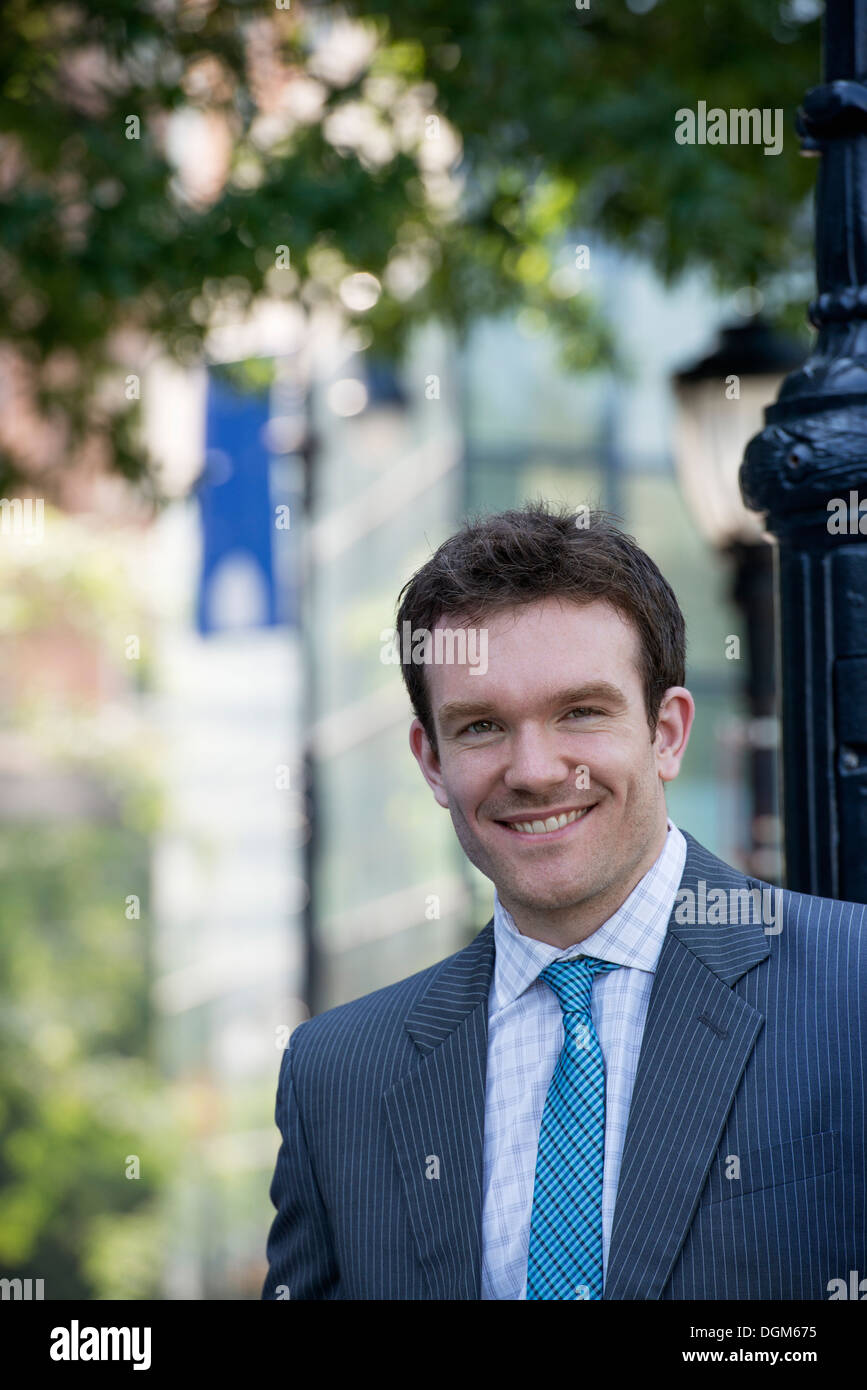 Summer. A young man in a grey suit and blue tie Stock Photo - Alamy
