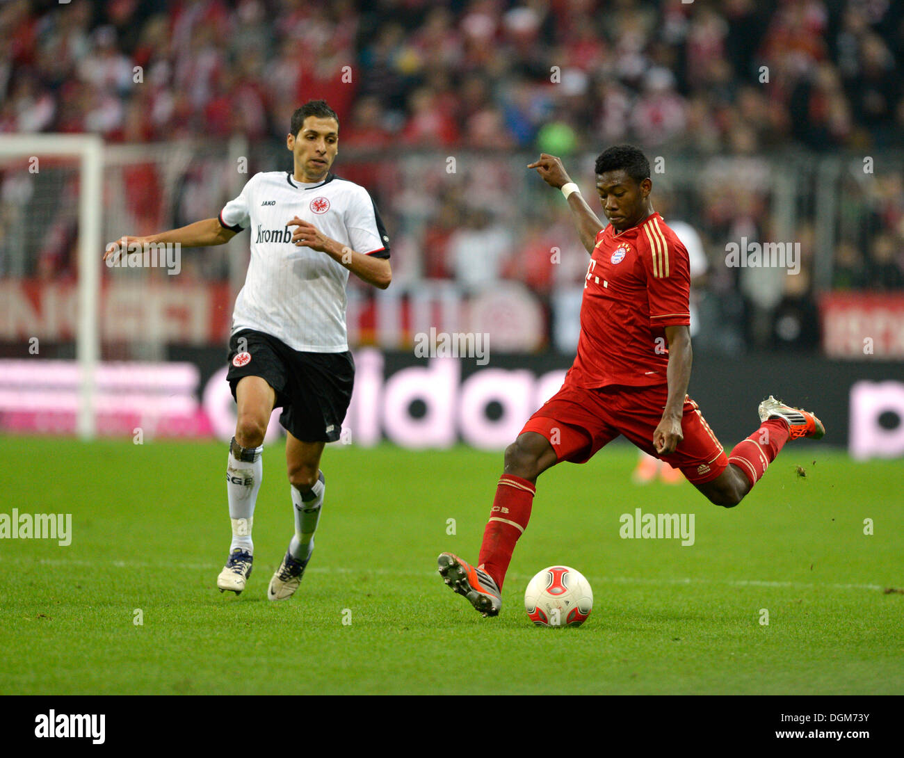 David Alaba, FC Bayern Munich, right, kicking the ball a, and Karim Matmour, Eintracht Frankfurt, left, Allianz Arena, Munich Stock Photo