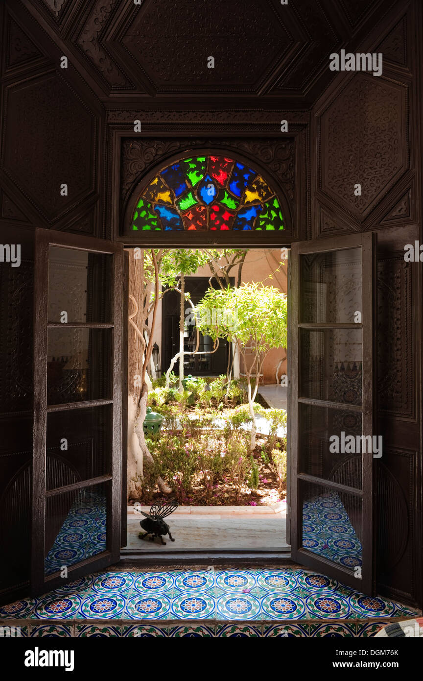 Beautiful handcrafted stained glass above doorway to Moroccan riad. Stock Photo