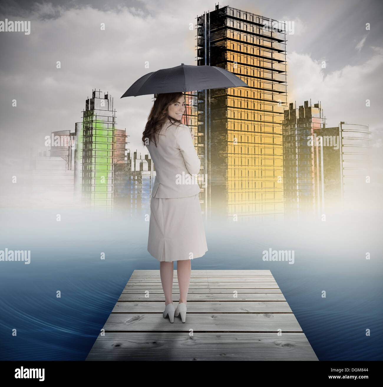 Smiling businesswoman standing on bridge in front of colorful city Stock Photo