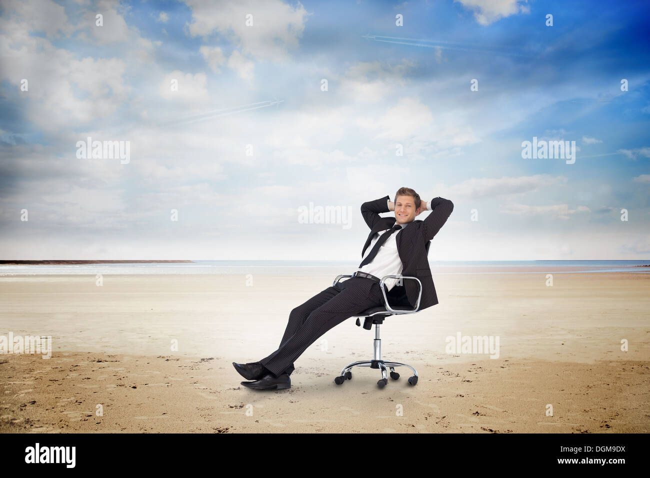 Young businessman sitting on swivel chair Stock Photo