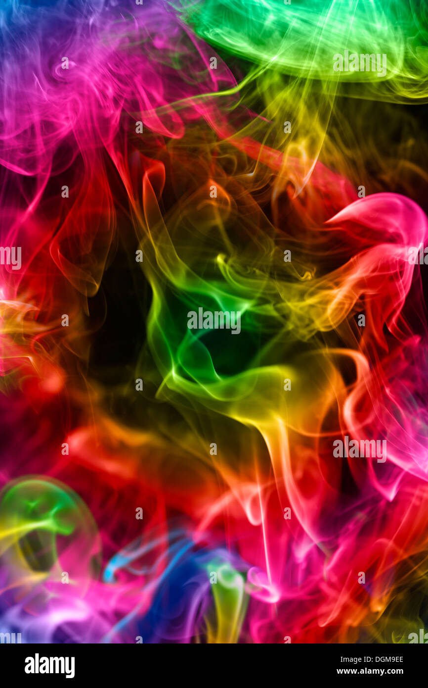 Multi-coloured smoke on a black background Stock Photo - Alamy