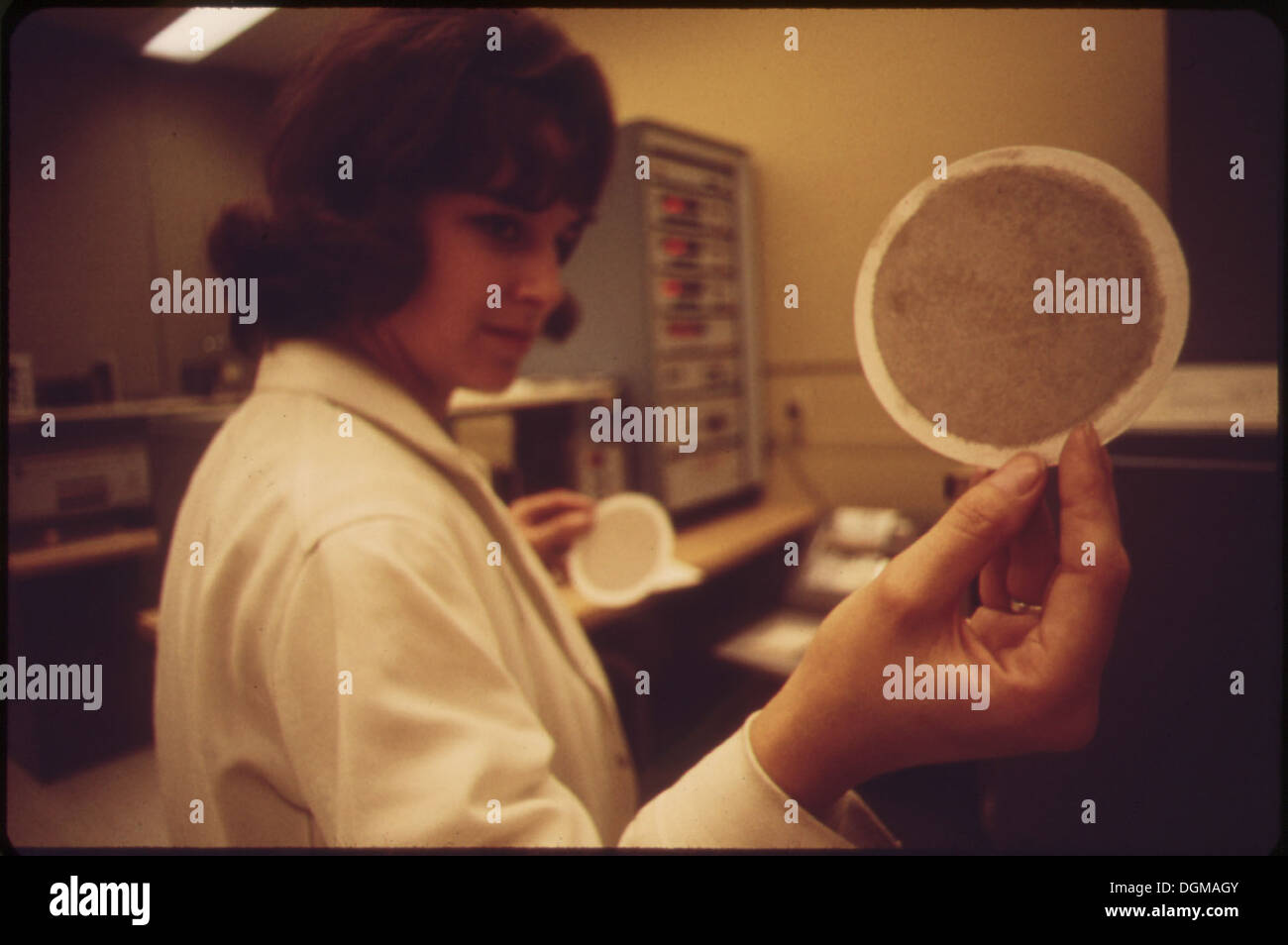 LABORATORY AT EPA'S LAS VEGAS NATIONAL RESEARCH CENTER TECHNICIAN HOLDS UP AN AIR FILTER 548891