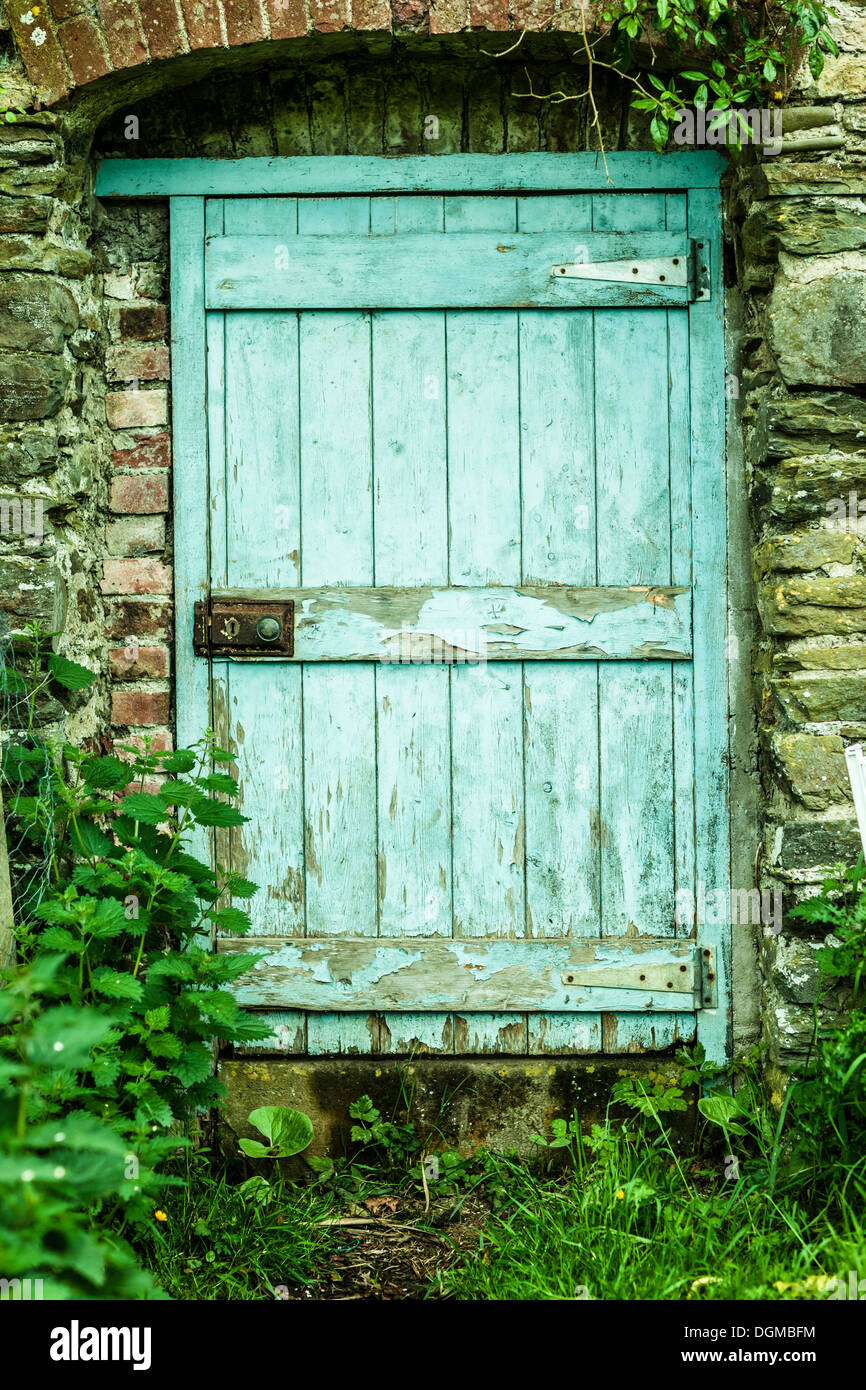 Blue wooden door in a stone wall Stock Photo - Alamy