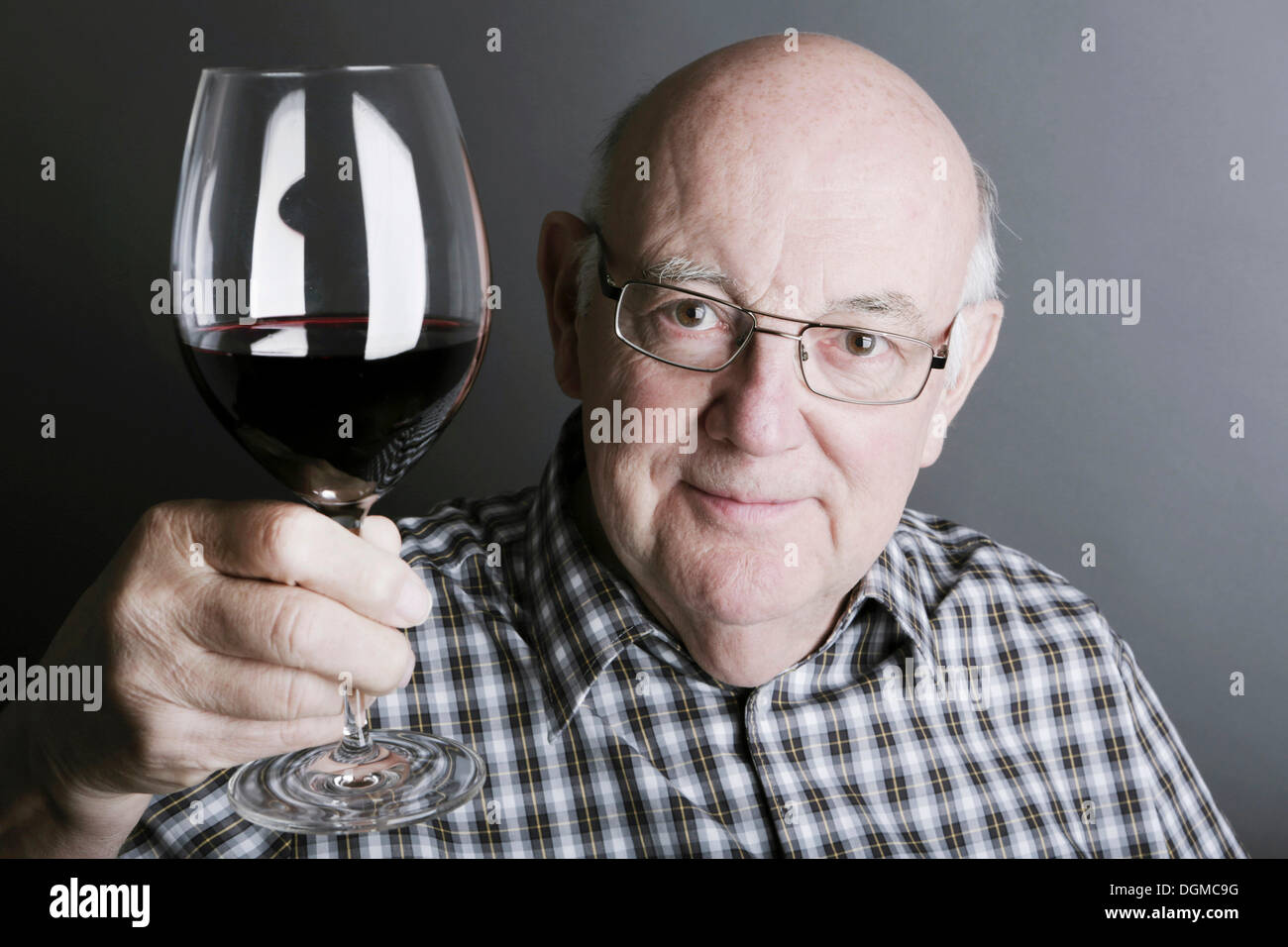 Senior citizen, elderly man, with a glass of wine Stock Photo