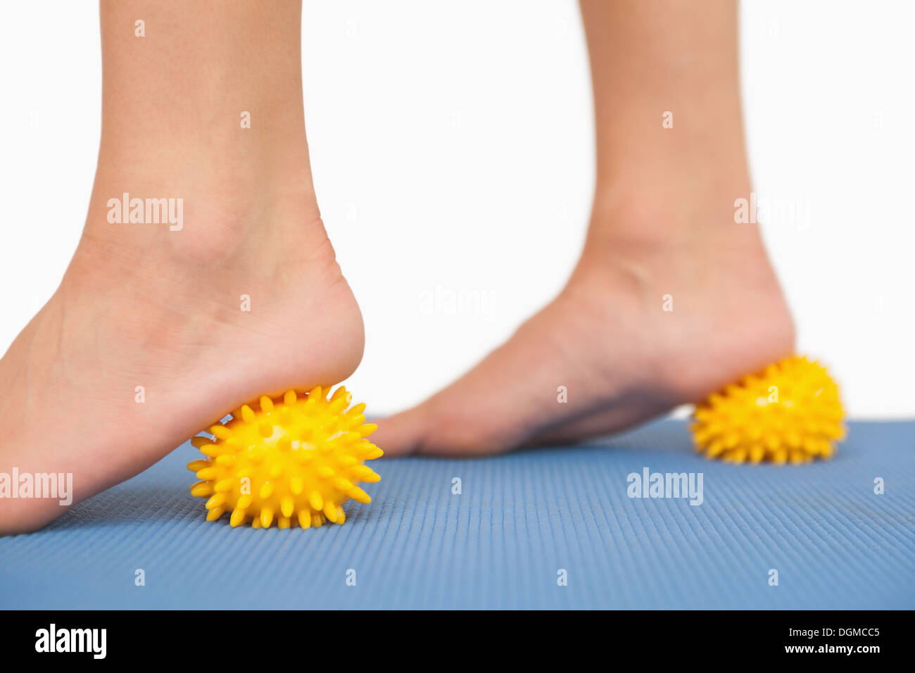 Female feet touching yellow massage ball Stock Photo Alamy