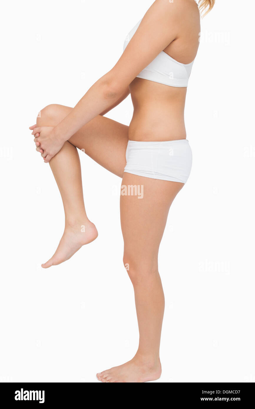 Sporty woman stretching her legs Stock Photo