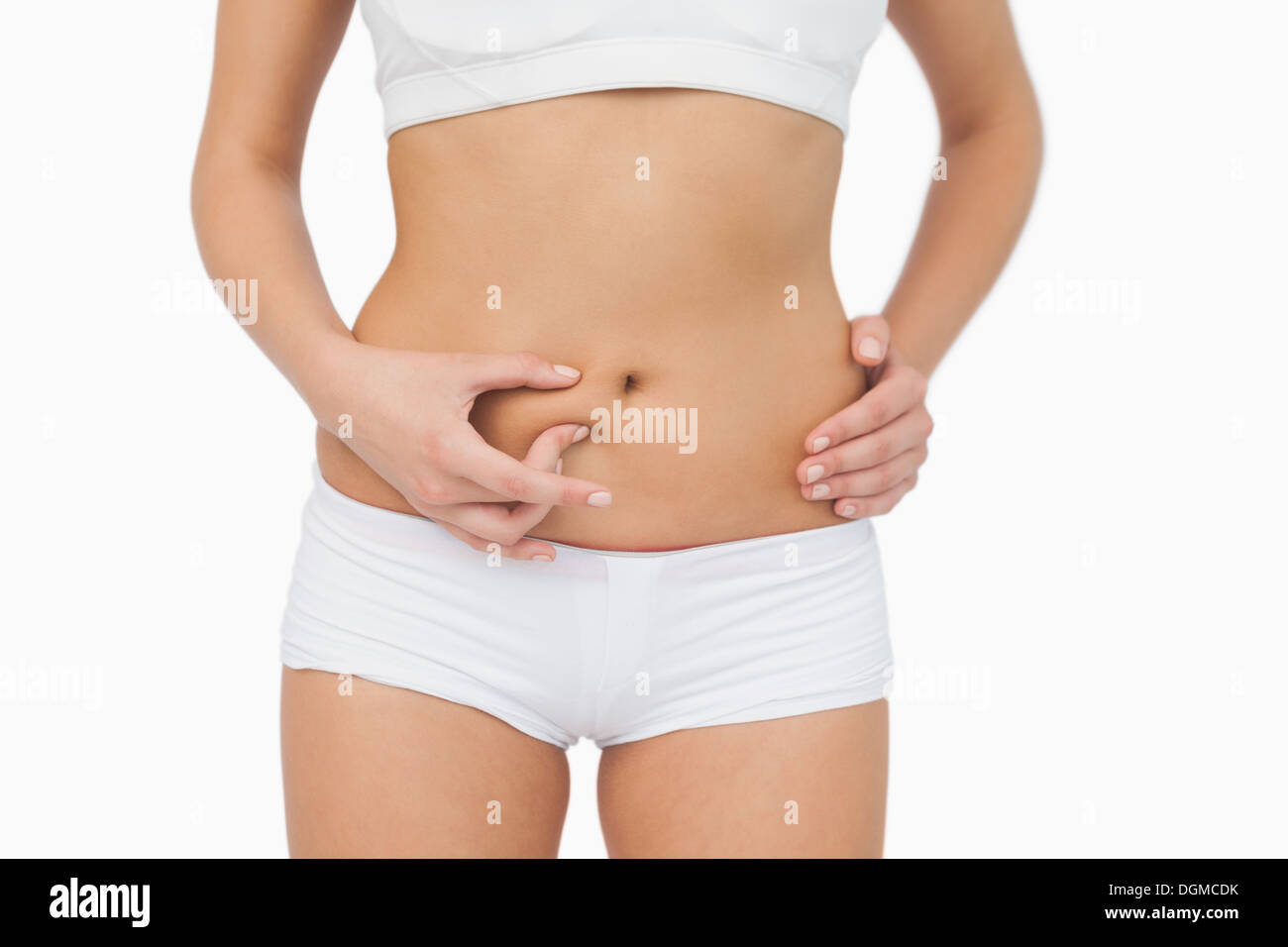 Slim young woman without any fat on her belly Stock Photo