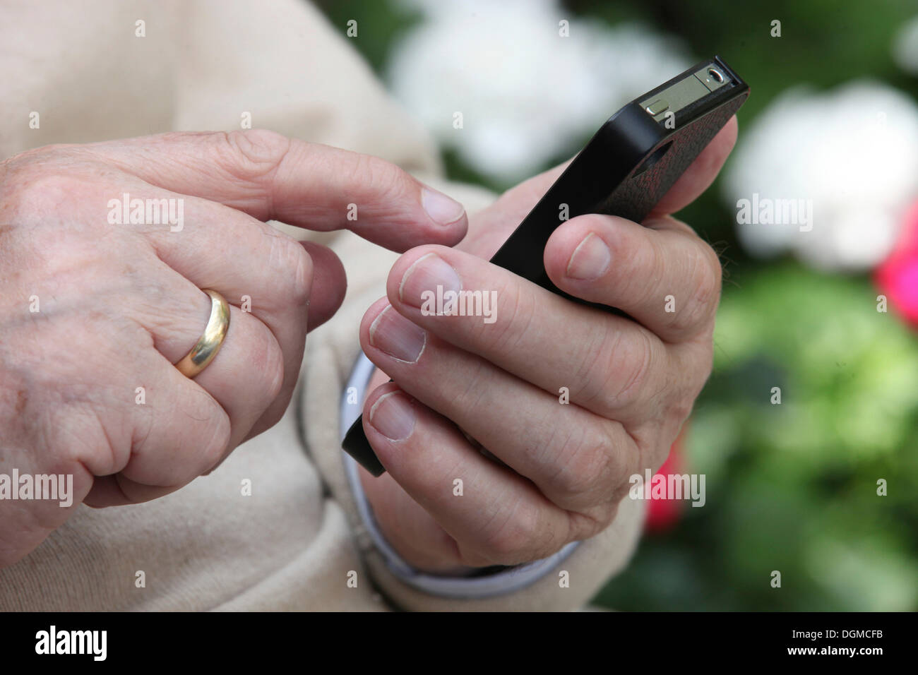Elderly man holding a smartphone in his hand Stock Photo