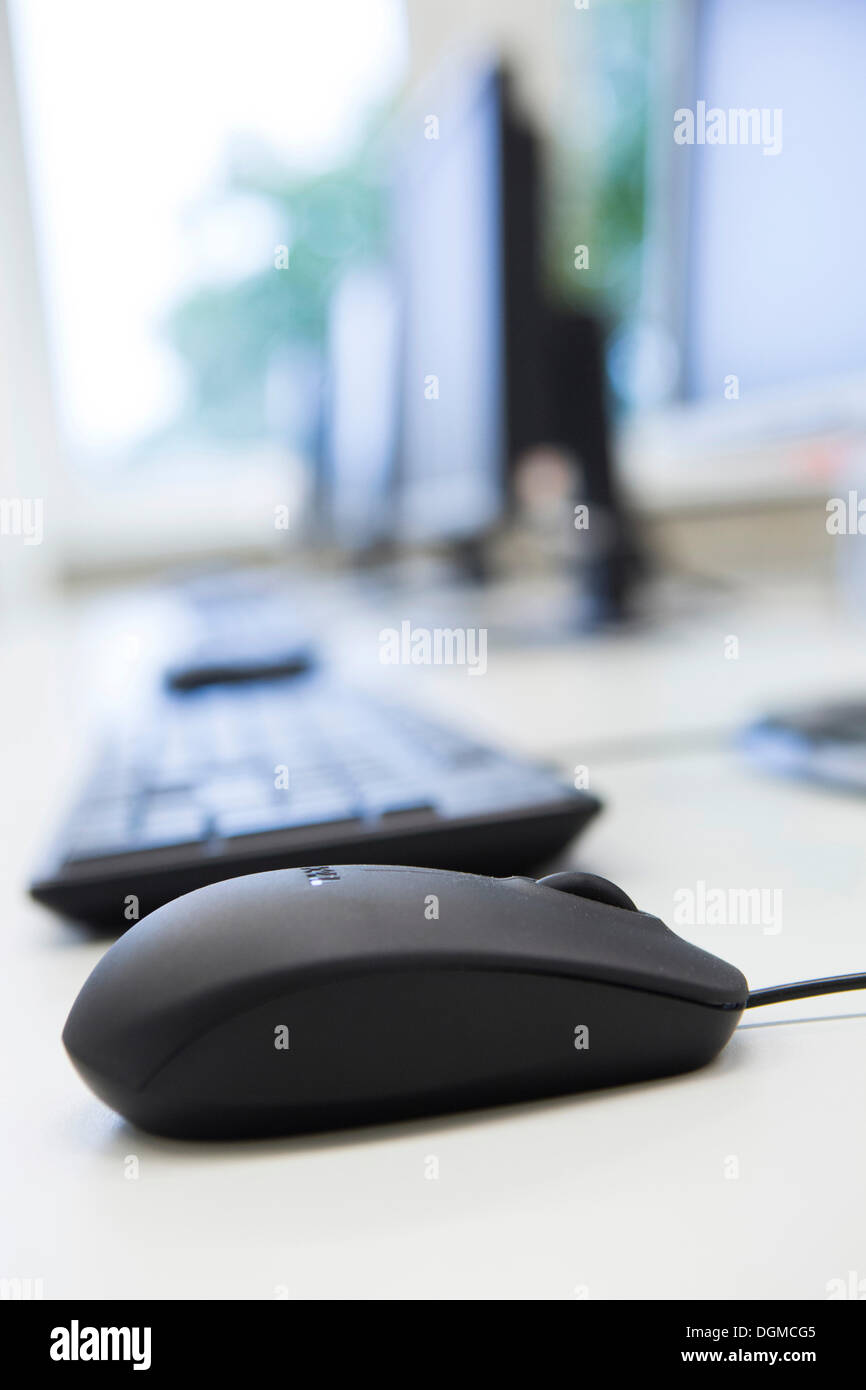 Computer monitors, keyboards and mouse in a training classroom Stock Photo