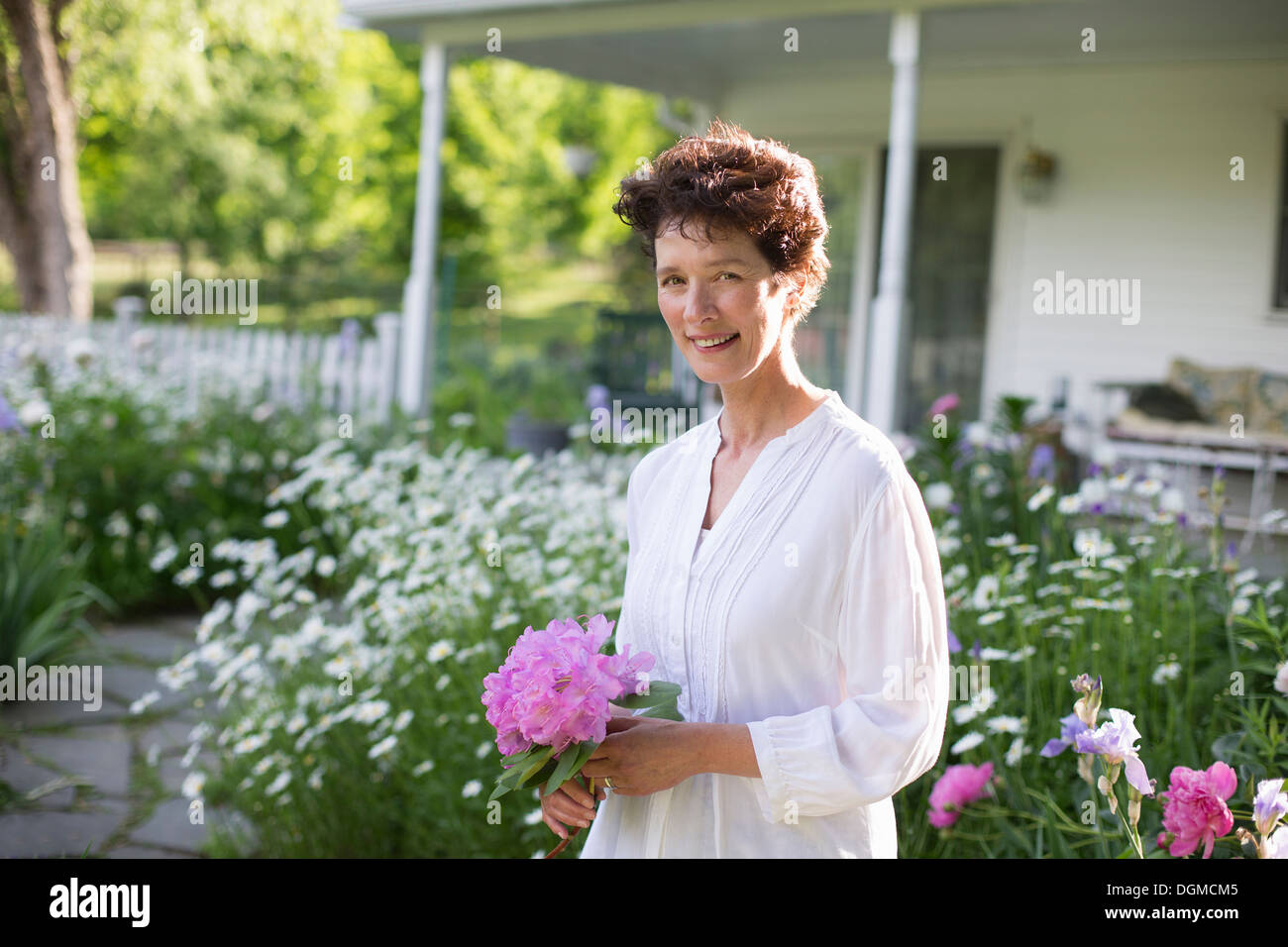 Organic farm. Summer party. A woman holding a bunch of flowers. Stock Photo