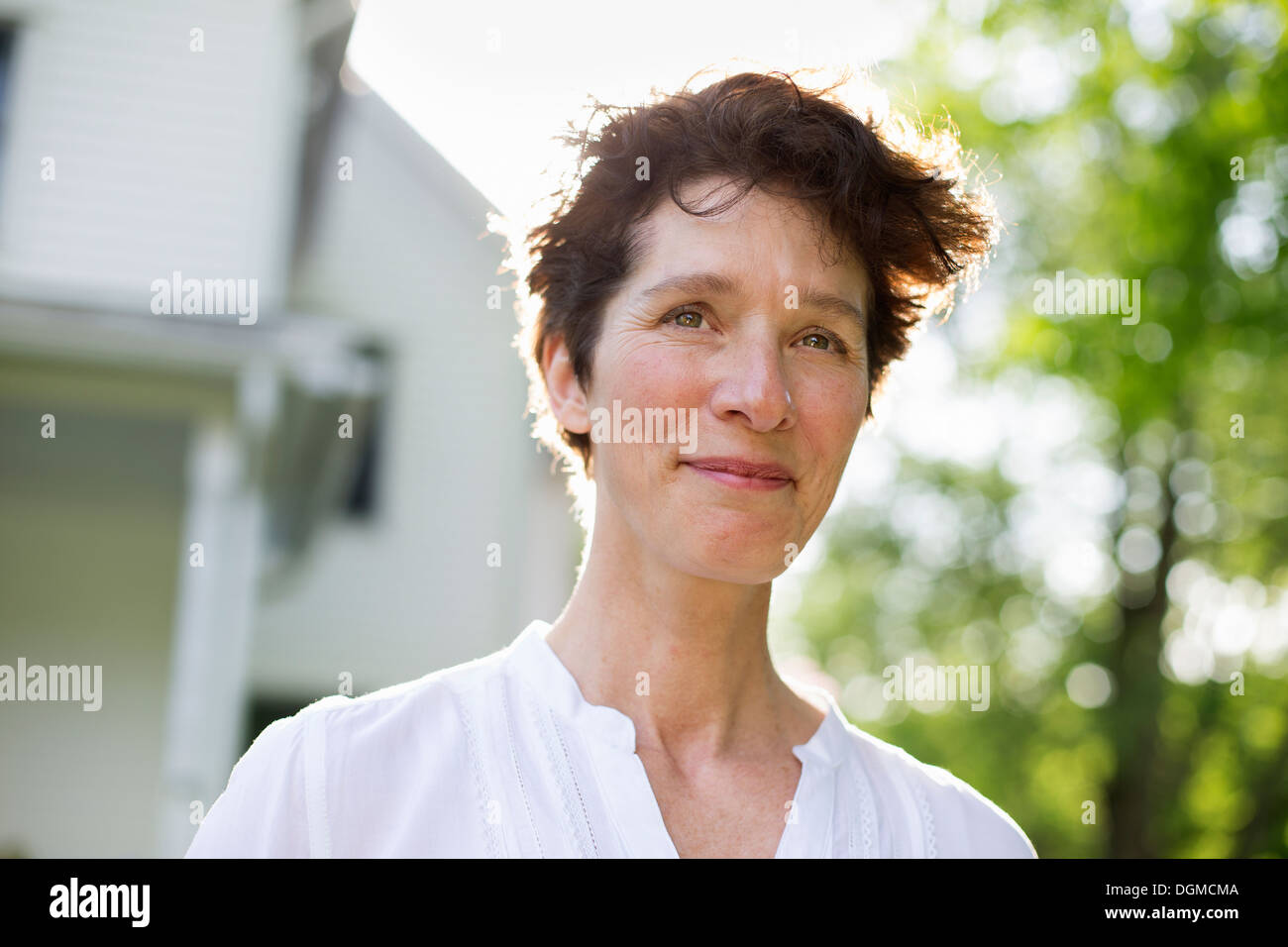 Organic farm. Summer party. A mature woman smiling. Stock Photo