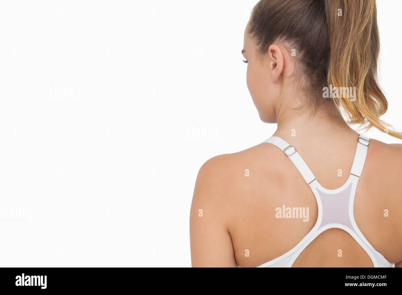Rear view of ponytailed young woman wearing a sports bra Stock Photo