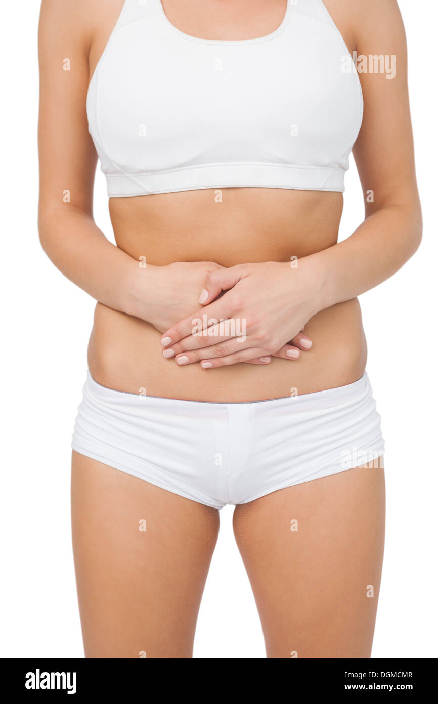 Mid section of young woman touching her belly with her hands Stock Photo